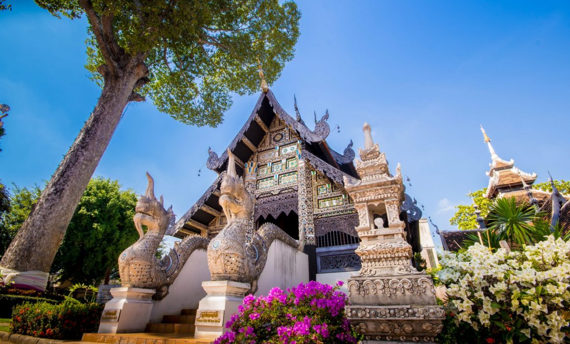 Wat Inthakin surrounded by flowers and tree