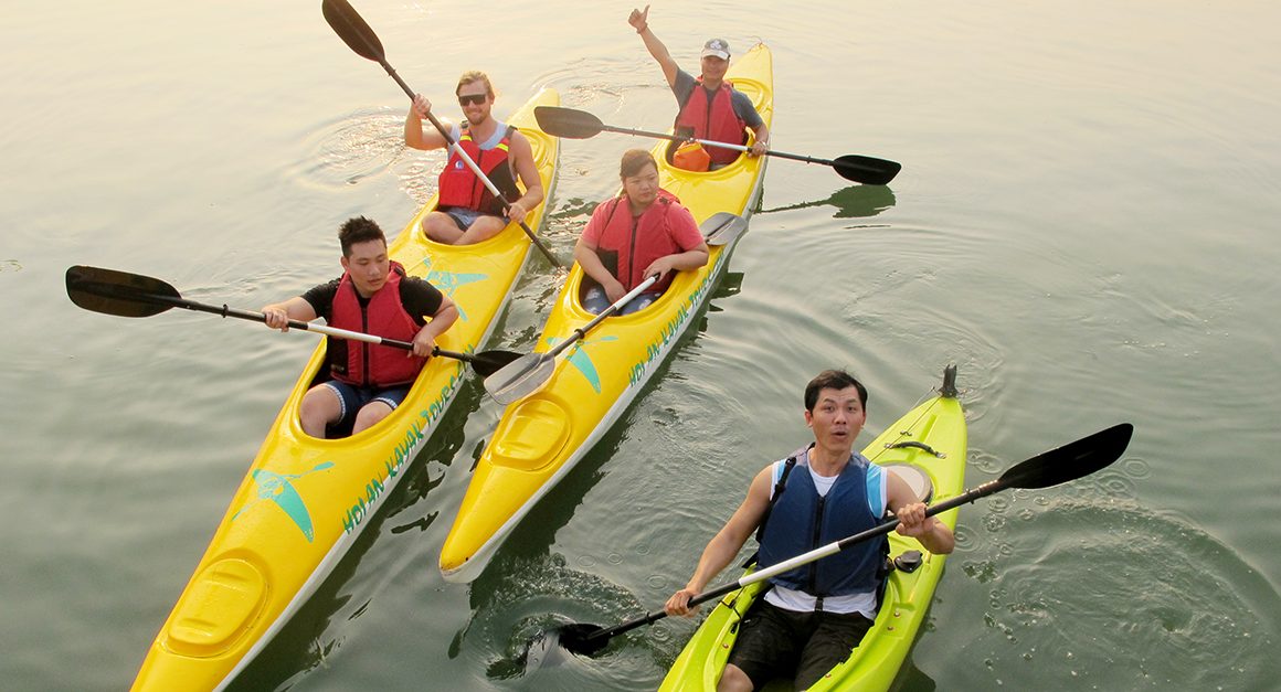 Five travelers in kayaks on the waterways of Hoi An