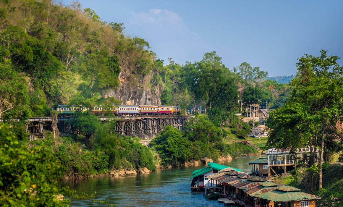 River, floating houses and train on tracks