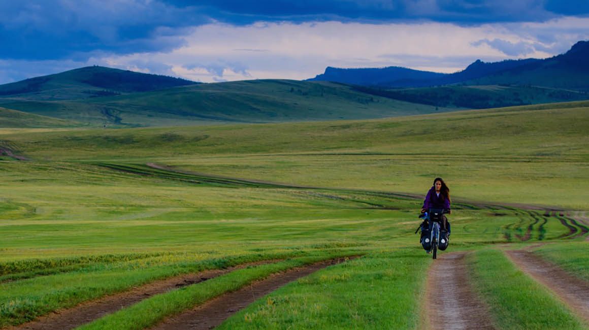 Person riding through plains of Mongolia