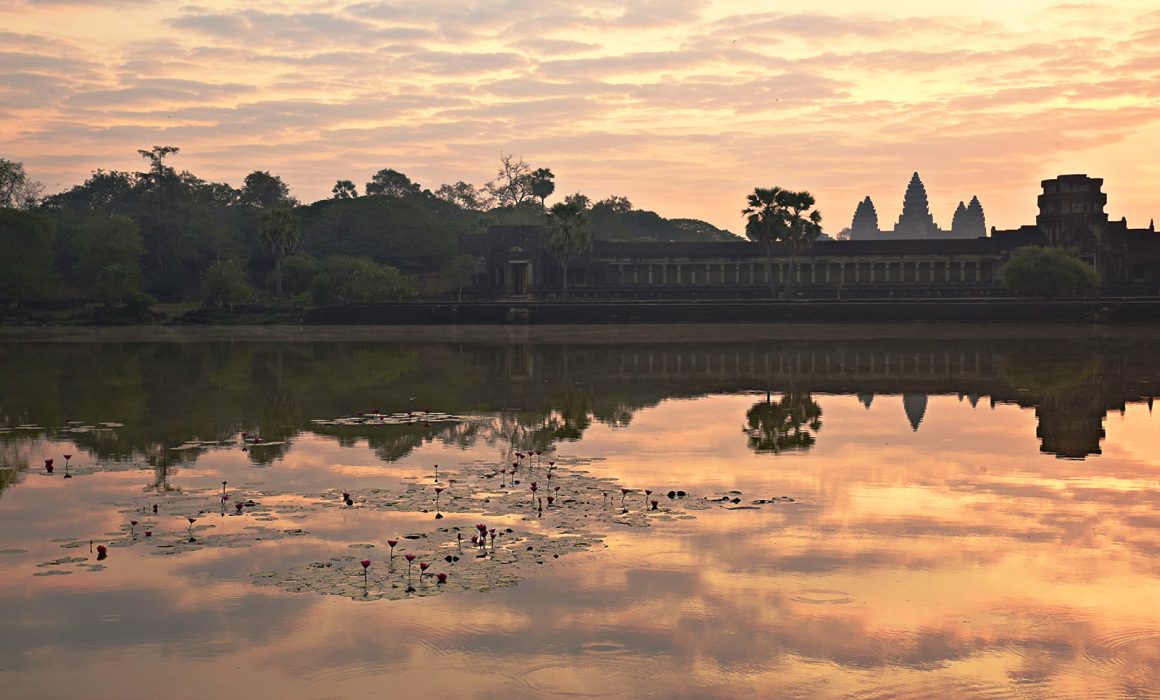 reflection of sky in water in front of Angkor Wat temple