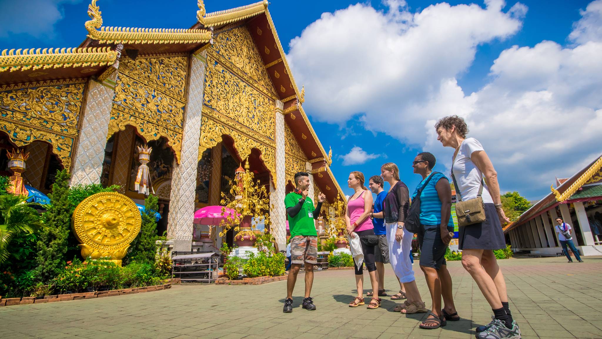 Guide talking to five travelers outisde of Wat Phra That Doi Suthep in Chiang Mai Thailand