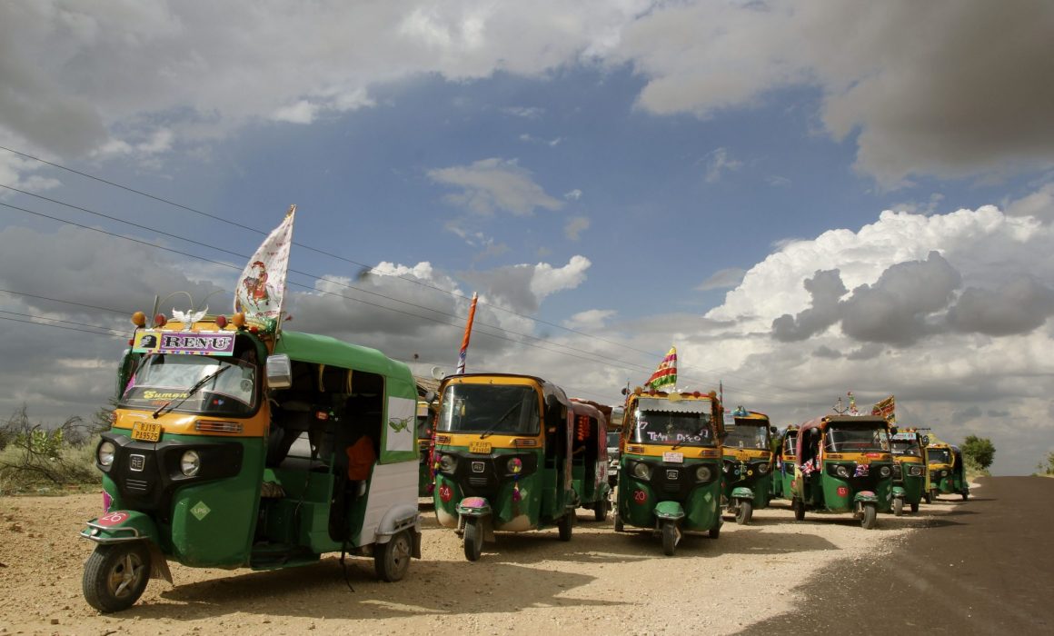 Group of rickshaws under cloudy skies