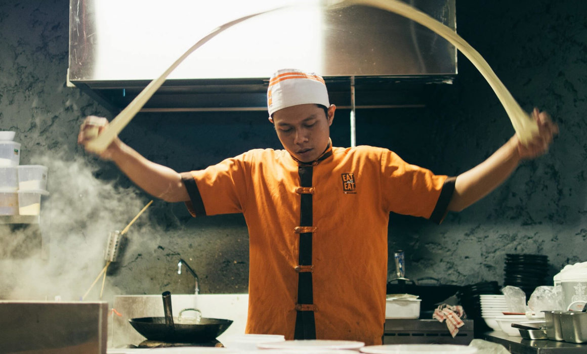 asian chef making noodles